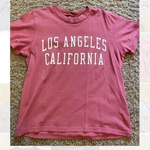 pink crop top, no size but fits very small, “los angeles california” on front
